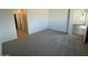 Cozy bedroom featuring neutral carpet floors and white walls at 25156 W Wayland Dr, Buckeye, AZ 85326