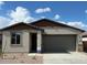 Charming single-story home featuring a neutral color palette, a two-car garage, and low maintenance landscaping at 25156 W Wayland Dr, Buckeye, AZ 85326