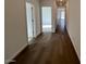 Hallway featuring hardwood floors and white walls at 25156 W Wayland Dr, Buckeye, AZ 85326