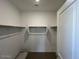 A walk-in closet featuring built in shelving and a clothing rod at 25156 W Wayland Dr, Buckeye, AZ 85326