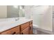 Bathroom featuring a wood cabinet vanity with a sink and a glass-door shower at 2600 E Springfield Pl # 10, Chandler, AZ 85286