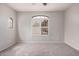 Bright bedroom with a light gray paint, carpet, and a large window that provides natural lighting at 2600 E Springfield Pl # 10, Chandler, AZ 85286