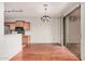 Open kitchen and dining area with hardwood floors and modern lighting at 2600 E Springfield Pl # 10, Chandler, AZ 85286