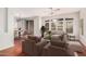 Bright living room featuring a ceiling fan, hardwood floors, and plentiful light from large windows at 2600 E Springfield Pl # 10, Chandler, AZ 85286