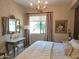 Elegant main bedroom featuring a large window, dressing table, and stylish decor at 3131 N Central Ave # 3001, Phoenix, AZ 85012
