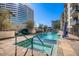 Stunning pool featuring comfortable lounge seating, lush landscaping, a jacuzzi, and clear blue water at 3131 N Central Ave # 3001, Phoenix, AZ 85012