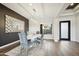 Bright dining room featuring a chic chandelier, modern decor, and wood flooring in a well-lit setting at 3244 E Daley Ln, Phoenix, AZ 85050