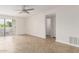 Bright and airy living room featuring a ceiling fan and access to outdoor patio space at 3314 N 68Th St # 247, Scottsdale, AZ 85251