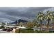 Scenic view of neighborhood homes with lush palm trees and iconic mountain backdrop under a cloudy sky at 3314 N 68Th St # 247, Scottsdale, AZ 85251