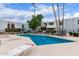Refreshing community pool with lounge chairs surrounded by manicured landscaping and inviting residential buildings at 3314 N 68Th St # 247, Scottsdale, AZ 85251