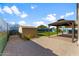 View of backyard with storage shed, covered patio area, and landscaped ground at 33290 N Roadrunner Ln, San Tan Valley, AZ 85144