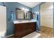 Stylish bathroom featuring a double vanity, dual framed mirrors, and a separate shower and tub area at 33290 N Roadrunner Ln, San Tan Valley, AZ 85144