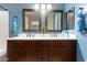 Elegant bathroom with a double vanity, framed mirrors, and ample counter space with convenient access to other rooms at 33290 N Roadrunner Ln, San Tan Valley, AZ 85144