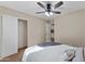 Bedroom with neutral color scheme, ceiling fan, closet, and an open door to the rest of the home at 33290 N Roadrunner Ln, San Tan Valley, AZ 85144