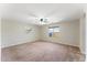 Expansive bedroom with plush carpet, neutral walls, ceiling fan, and a sunlit window offering pleasant views at 33290 N Roadrunner Ln, San Tan Valley, AZ 85144