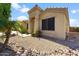 A close up exterior showing the desert landscaping with decorative rocks and plants, and covered entry at 33290 N Roadrunner Ln, San Tan Valley, AZ 85144