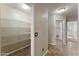 Hallway featuring wood-style tile flooring with access to the walk-in pantry at 33290 N Roadrunner Ln, San Tan Valley, AZ 85144