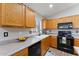 The Kitchen features wooden cabinets, black appliances, and a large sink with natural light at 33290 N Roadrunner Ln, San Tan Valley, AZ 85144