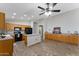 Spacious kitchen with tile floors, center island, and wood cabinets offers a warm and inviting space at 33290 N Roadrunner Ln, San Tan Valley, AZ 85144