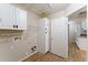 Laundry room with white cabinets, white shelving, and wood-look flooring, for easy cleaning at 33290 N Roadrunner Ln, San Tan Valley, AZ 85144