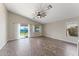 Spacious living room with tiled floor, vaulted ceilings, and sliding doors to the backyard at 33290 N Roadrunner Ln, San Tan Valley, AZ 85144