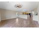 Spacious living room featuring wood tile flooring, view to the kitchen, and natural light at 33290 N Roadrunner Ln, San Tan Valley, AZ 85144