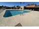 Large community pool surrounded by lounge chairs and palm trees, perfect for relaxation and recreation at 3345 E University Dr # 29, Mesa, AZ 85213
