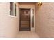 Attractive front door with security screen, sidelight window, and sconce lighting at 3345 E University Dr # 29, Mesa, AZ 85213