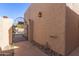 Inviting gated entrance with a charming wall lamp and manicured landscaping at 3345 E University Dr # 29, Mesa, AZ 85213
