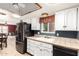 Bright kitchen with white cabinets, tile countertops, and black appliances at 3345 E University Dr # 29, Mesa, AZ 85213