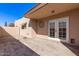 Covered patio with brick flooring, white double doors, exterior door, and decorative wall art at 3345 E University Dr # 29, Mesa, AZ 85213