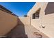 Private patio with stucco walls, brick pavers and window offers a secluded outdoor retreat at 3345 E University Dr # 29, Mesa, AZ 85213