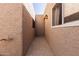 Enclosed walkway with textured walls, tiled floors, and ambient wall lighting at 3345 E University Dr # 29, Mesa, AZ 85213