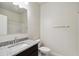 Bathroom featuring a vanity with granite countertop, a large mirror, and a toilet at 35569 N Breezy Ln, San Tan Valley, AZ 85140