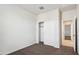 Bright bedroom with neutral walls, plush carpet, and a closet with sliding doors at 35569 N Breezy Ln, San Tan Valley, AZ 85140