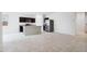 Spacious kitchen area with dark cabinets, granite countertops, stainless steel appliances and ample room for cooking at 35569 N Breezy Ln, San Tan Valley, AZ 85140