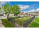 Fenced backyard featuring lush grass, mature trees, and a covered outdoor dining area for entertainment and relaxation at 4113 N 10Th Pl, Phoenix, AZ 85014