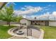 Expansive backyard featuring a stone firepit, lush green lawn, and patio area with desert landscaping at 4113 N 10Th Pl, Phoenix, AZ 85014