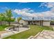 Spacious backyard features an outdoor firepit with stone accents and ample green space for activities at 4113 N 10Th Pl, Phoenix, AZ 85014