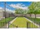 Large backyard features a metal fence, manicured grass and decorative rock features, creating a serene retreat at 4113 N 10Th Pl, Phoenix, AZ 85014