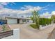 Well-maintained single-story home with a spacious concrete driveway, garage and grassy front yard at 4113 N 10Th Pl, Phoenix, AZ 85014