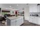Bright kitchen featuring a center island with granite countertops, white cabinets, and open concept living area at 4113 N 10Th Pl, Phoenix, AZ 85014