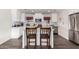 Bright kitchen featuring a center island with granite countertops, stainless steel refrigerator, and breakfast bar seating at 4113 N 10Th Pl, Phoenix, AZ 85014