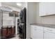 Functional laundry room with modern black washer and dryer units, and white cabinets for storage at 4113 N 10Th Pl, Phoenix, AZ 85014