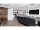 Open-concept living room with wood floors, modern lighting, and a seamless flow into the kitchen at 4113 N 10Th Pl, Phoenix, AZ 85014