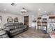 Open-concept living room featuring wood floors, modern lighting, and seamless flow into kitchen at 4113 N 10Th Pl, Phoenix, AZ 85014