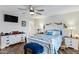 Serene bedroom with white furniture, ceiling fan, and a calming view from the bright window at 4432 E Carmel Ave, Mesa, AZ 85206