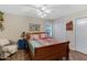 Comfortable bedroom with ceiling fan and colorful bedding and decor, plus cozy armchair at 4432 E Carmel Ave, Mesa, AZ 85206