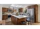 Charming kitchen featuring stainless steel appliances, wood cabinets, mosaic backsplash, and center island with countertop seating at 4432 E Carmel Ave, Mesa, AZ 85206