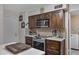 Well-appointed kitchen featuring wooden cabinets, stainless steel appliances, and a tile backsplash for a modern feel at 4432 E Carmel Ave, Mesa, AZ 85206